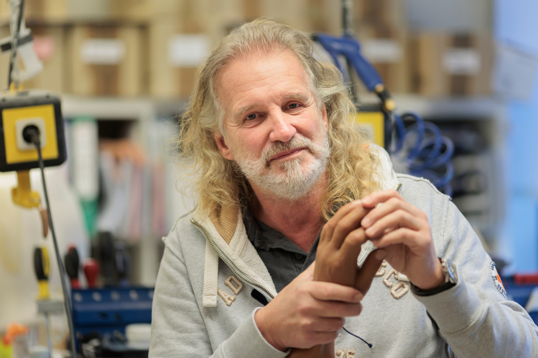 Man is holding a prosthetic hand