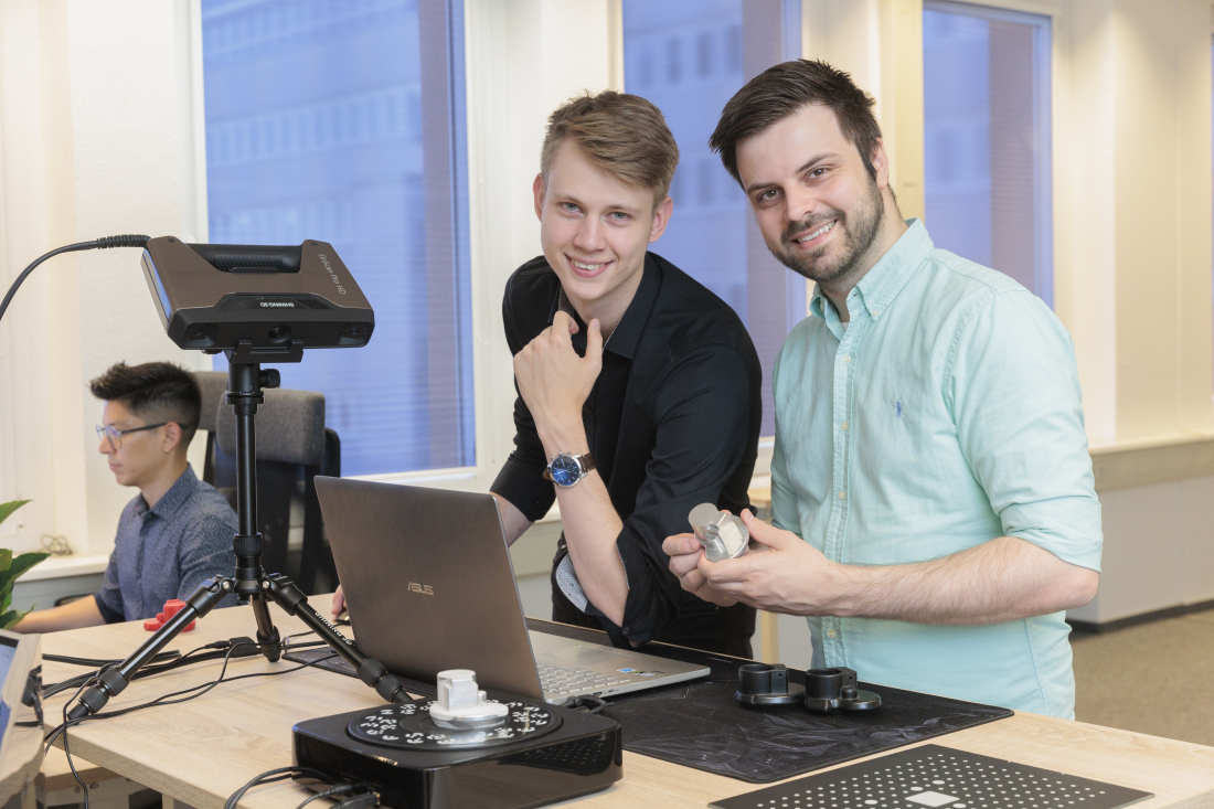 Two men in front of a computer