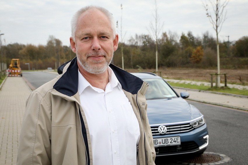 Professor Christof Büskens in front of a car