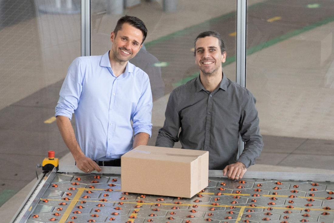 Hendrik Thamer (left) and co-founder Claudio Uriarte (right) with the Celluveyor system, which takes up 95 per cent less space than other conveyor systems. 