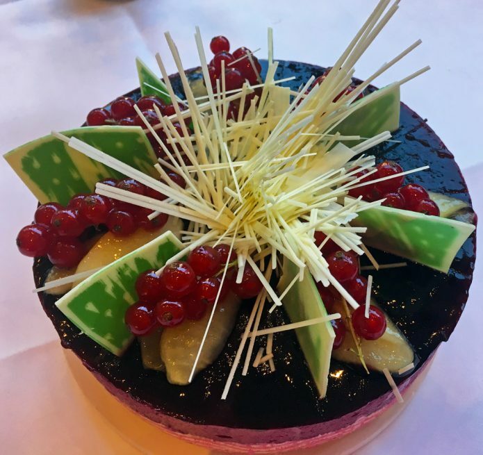 Cake decorated with fruit and chocolate