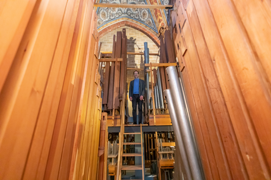 Stephan Leuthold steht zwischen den Pfeifen der Sauer-Orgel. 