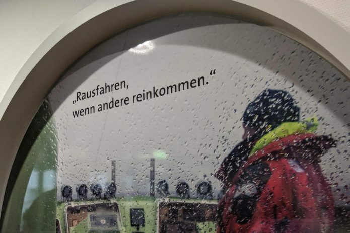 Das Zitat "Rausfahren, wenn andere reinkommen" steht neben einem Seenotretter auf einem Boot, der gerade rausfährt